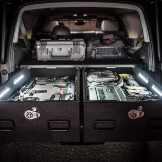 Chevrolet Tahoe with TruckVault drawers open showing gear illuminated by TruckVault LED lights