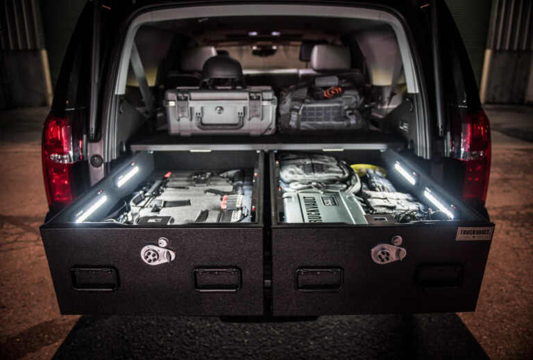 Chevrolet Tahoe with TruckVault drawers open showing gear illuminated by TruckVault LED lights