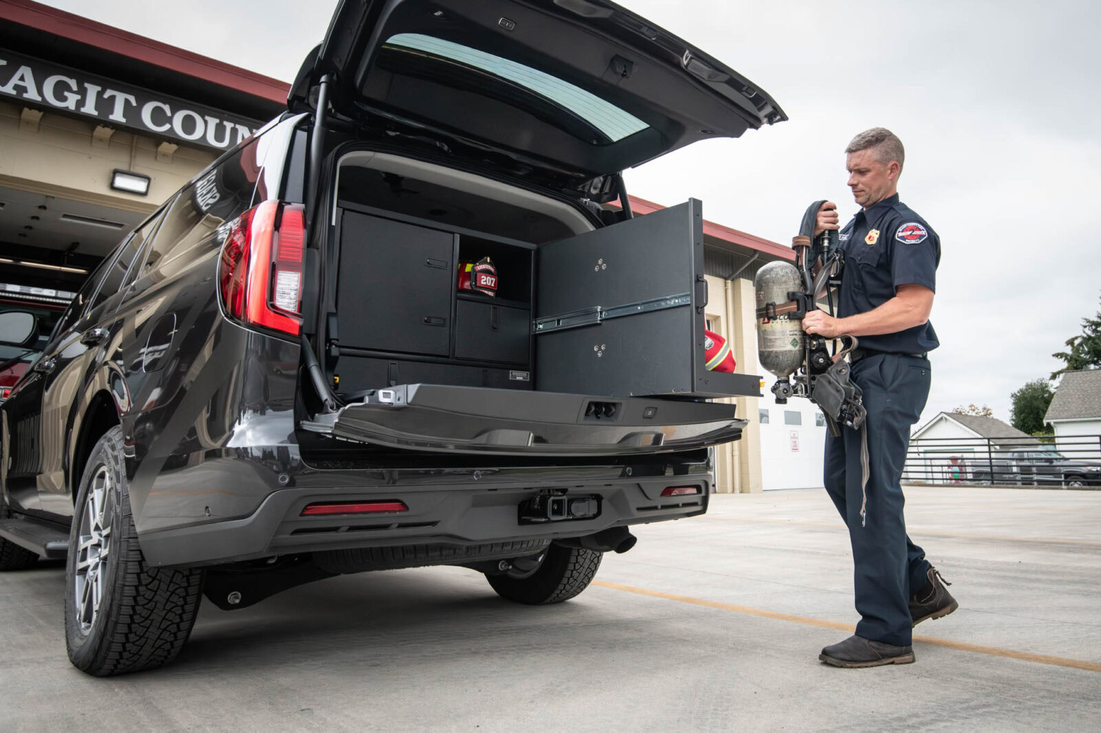 First responder loads gear into the EM9 HEPA TurnOut by TruckVault