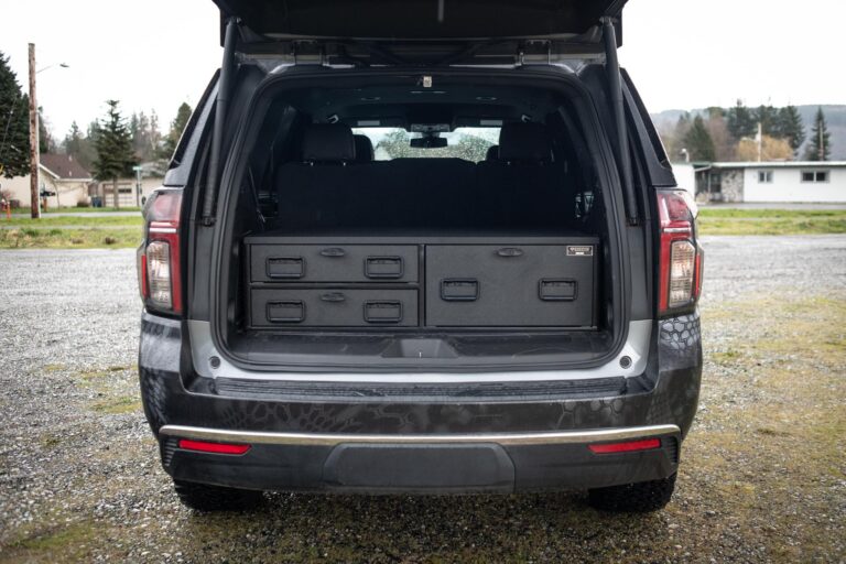 The open hatch of an SUV reveals an ST2 Field Ranger by TruckVault installed in the trunk,