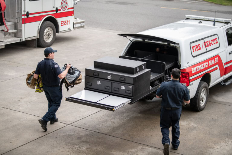 First responders load gear into the PL6 which is fully extended from their truck